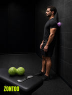 Zontoo Upper Body Recovery Kit in use — massage cone, peanut ball and steel scraper
